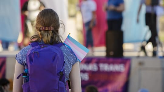 person holding hand with trans symbol
