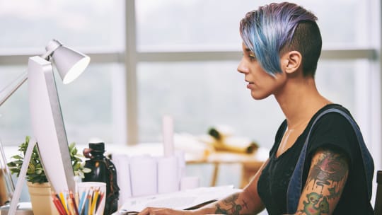 A woman types on a computer