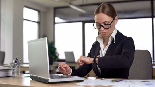 woman checking her watch at work