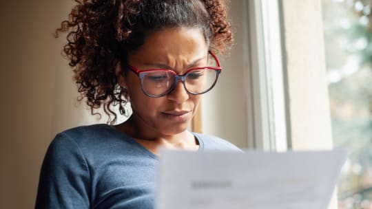 Woman looking at bills