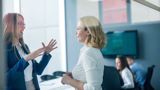 Coworkers talking in the office