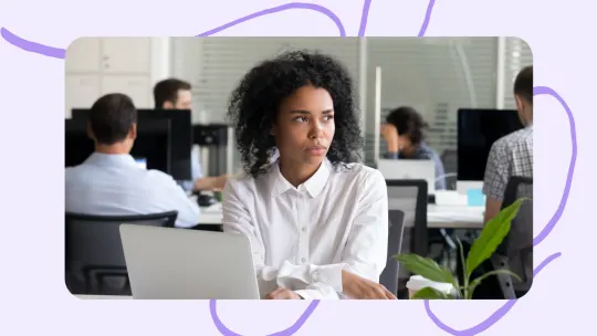 A woman looking unhappy at work. 