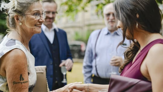 two women shaking hands at an event