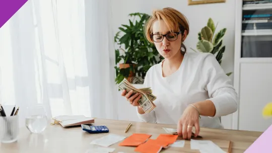 Women calculating money at home, illustrating how to make passive income