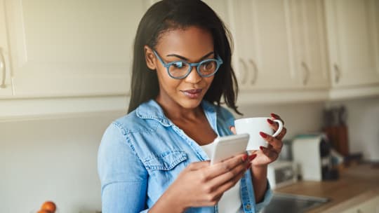 Woman drinking coffee on phone