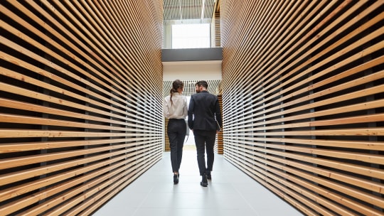 woman and man walking down office stairs