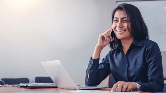 Woman smiling while talking on the phone