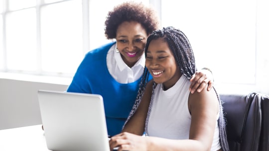 mother and daughter on a computer filling out work permit application