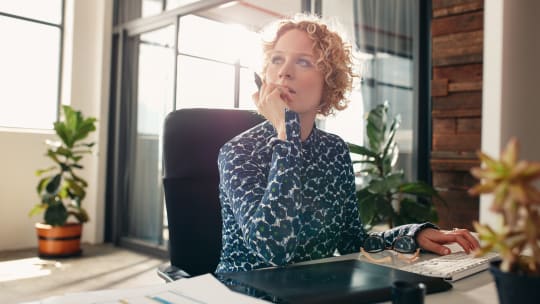 Woman thinking at desk