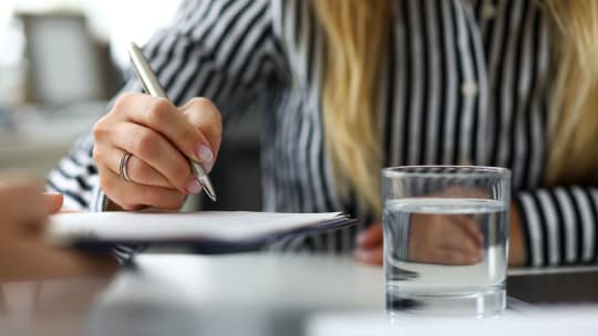 woman writing by hand