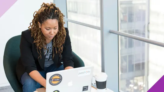 A professional working at a computer, illustrating how to make a career change at 40