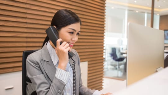 administrative assistant answering the phone