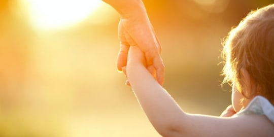 Mom holding child's hand