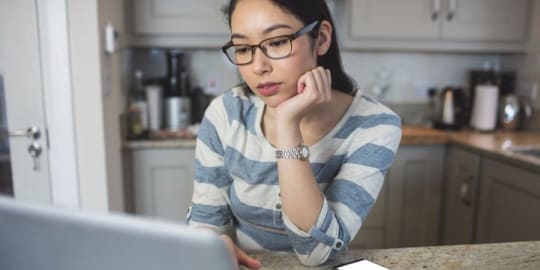 Woman thinking at computer