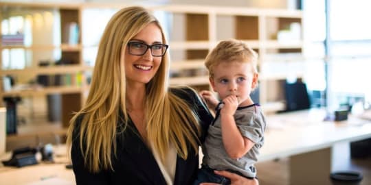 CEO mom holding son