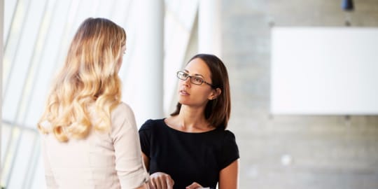 Two women talking in office