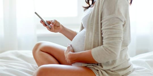 Pregnant woman on phone