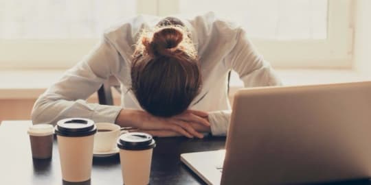 Woman with head on desk