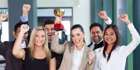 Diverse team with trophy