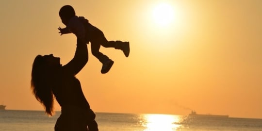 Silhouetted mother and daughter