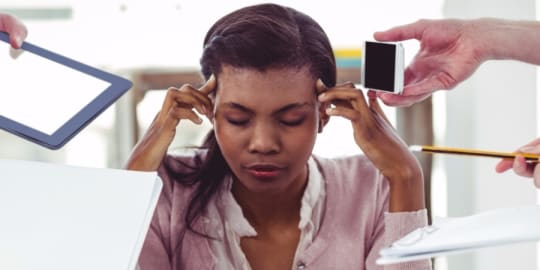 Woman with fingers on temples