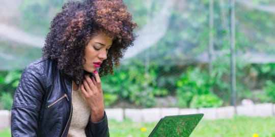 Woman looking at laptop