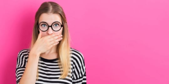 woman covering her mouth