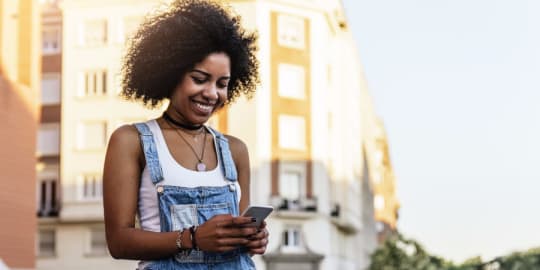 Woman laughing at phone