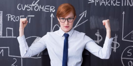 Determined woman in front of chalkboard