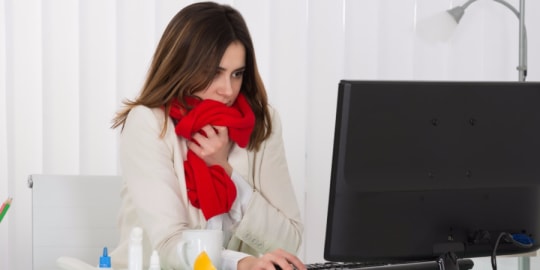 Sick woman at desk