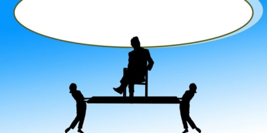 Women holding up male boss