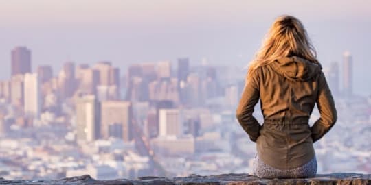 Woman in front of city