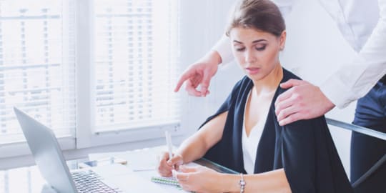 Man Touching Woman's Shoulder at Work