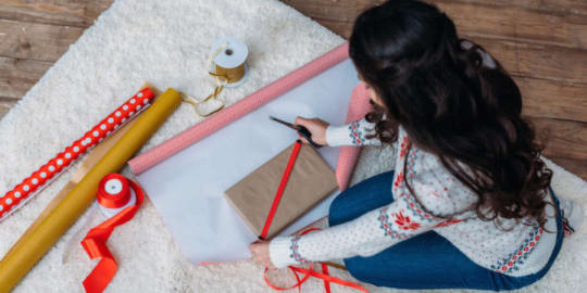 woman wrapping gifts