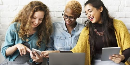 women reading on tablets