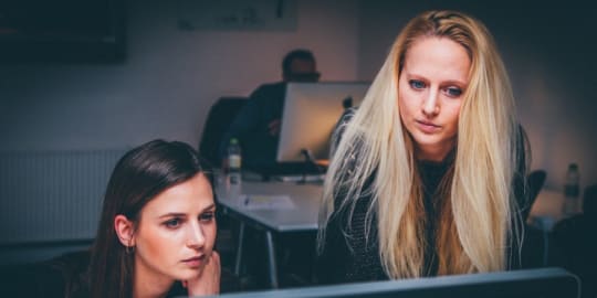 Mentor and mentee at a computer