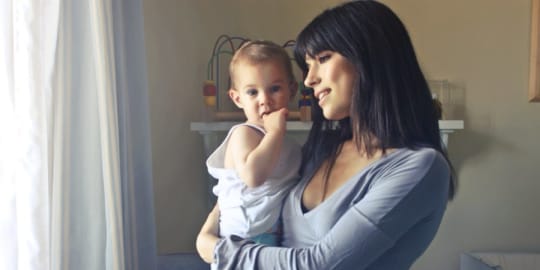 Working mother holding child