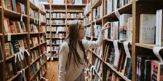Women looking for books in a library