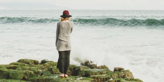 Woman planning future on a cliff
