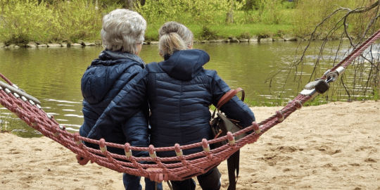 Adult woman and mother sitting in a hammock