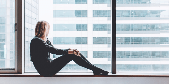 Woman with PMS looking out window