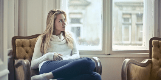 woman sitting in a chair by the window