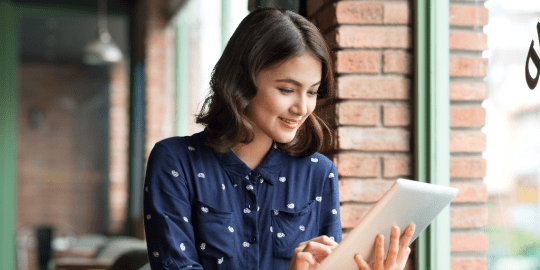 woman smiling at iPad