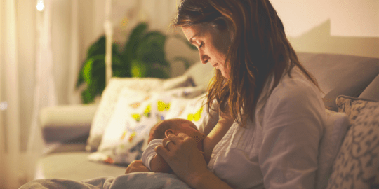 woman breastfeeding at home