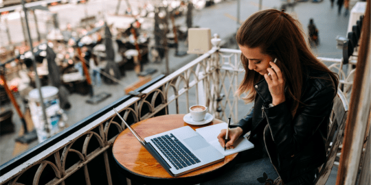 Woman Working on Computer at Beach