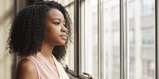 business woman looking out a window