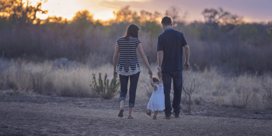 parents in the woods with daughter