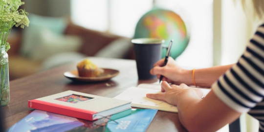 woman writing on a table