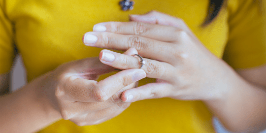 Woman taking off wedding ring