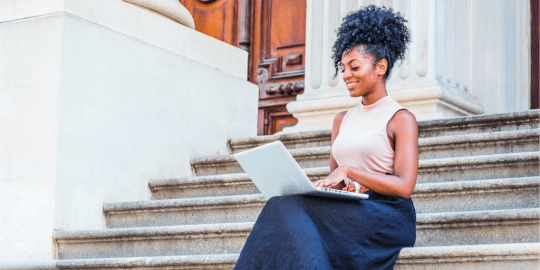 A woman sitting in front of a building